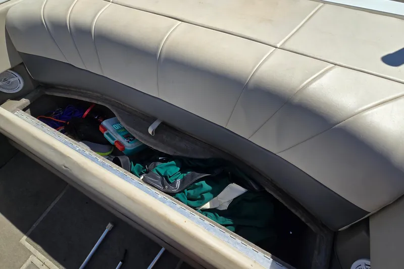 Slide: The Image of Storage compartment in a 1996 Cobalt 220 boat with various items inside. - 19