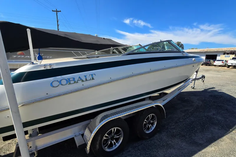 Slide: The Image of 1996 Cobalt 220 boat on trailer under clear blue sky. - 2