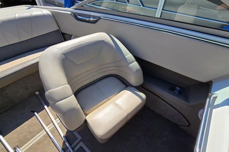 Slide: The Image of Interior of a 1996 Cobalt 220 boat with beige seating and cup holder. - 22