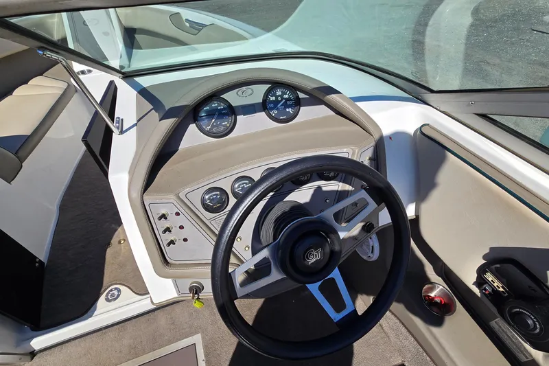 Slide: The Image of Interior of a 1996 Cobalt 220 boat showing steering wheel and dashboard controls. - 25
