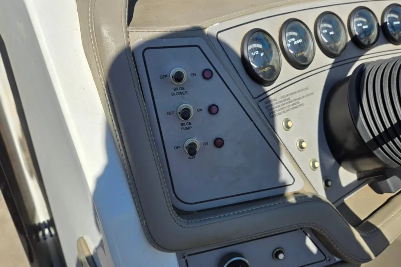 Slide: The Image of Control panel of a 1996 Cobalt 220 boat with switches and gauges. - 28
