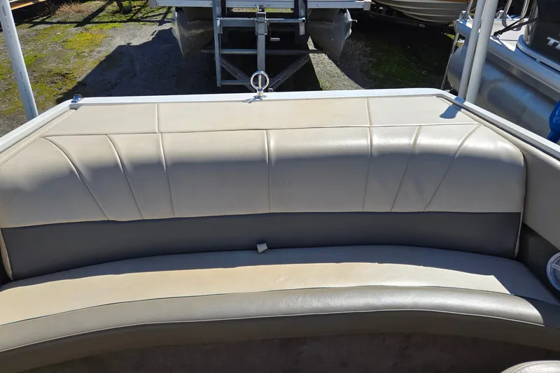 Slide: The Image of 1996 Cobalt 220 boat interior with beige seating, outdoor setting. - 31
