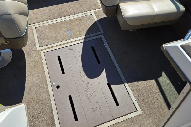 Slide: The Image of Interior of a 1996 Cobalt 220 boat with beige seating and carpeted flooring. - 32