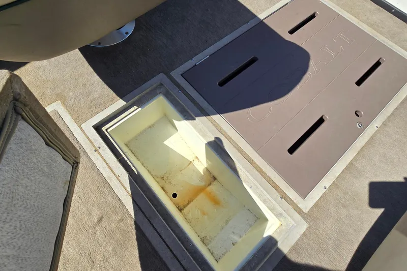 Slide: The Image of Open storage compartment on 1996 Cobalt 220 boat deck, showing interior details. - 35