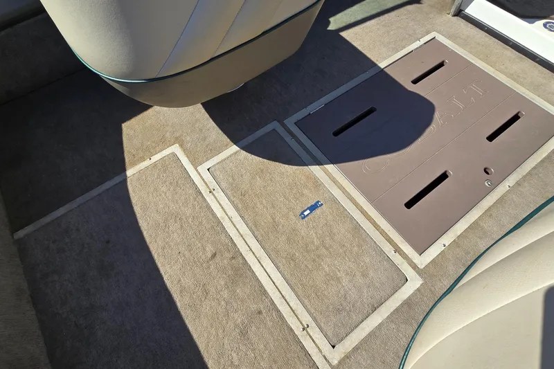 Slide: The Image of Interior of a 1996 Cobalt 220 boat showing carpeted floor and storage compartments. - 36