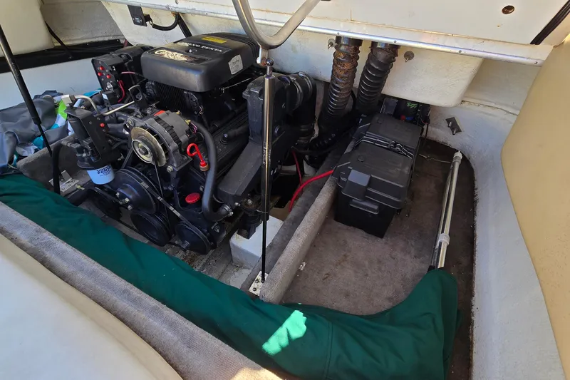 Slide: The Image of Engine compartment of a 1996 Cobalt 220 boat, showing motor and battery setup. - 37