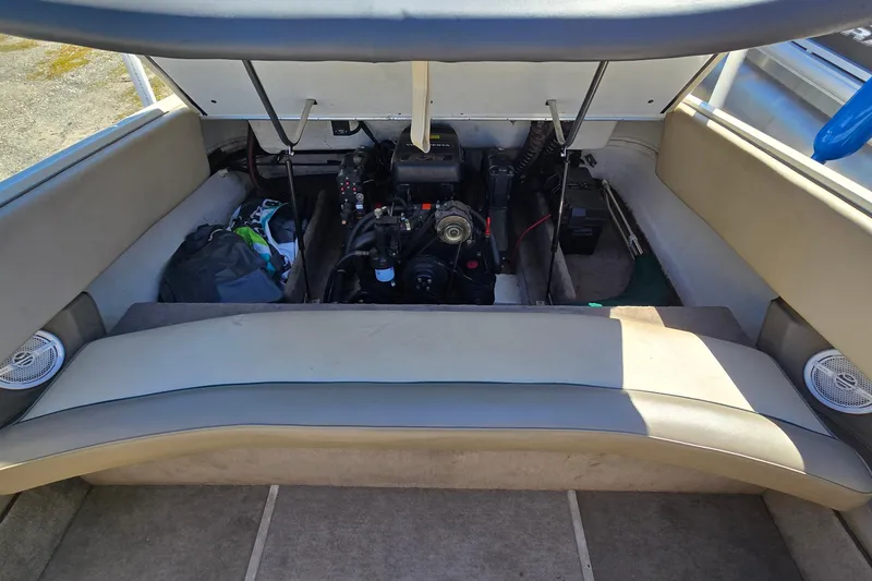 Slide: The Image of 1996 Cobalt 220 boat engine compartment with open hatch, revealing engine and storage area. - 42