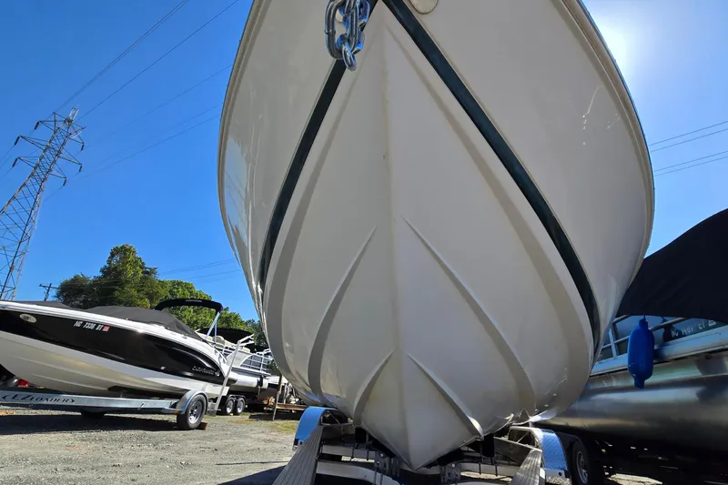 Slide: The Image of Close-up of a 1996 Cobalt 220 boat hull on a trailer, with other boats nearby. - 6