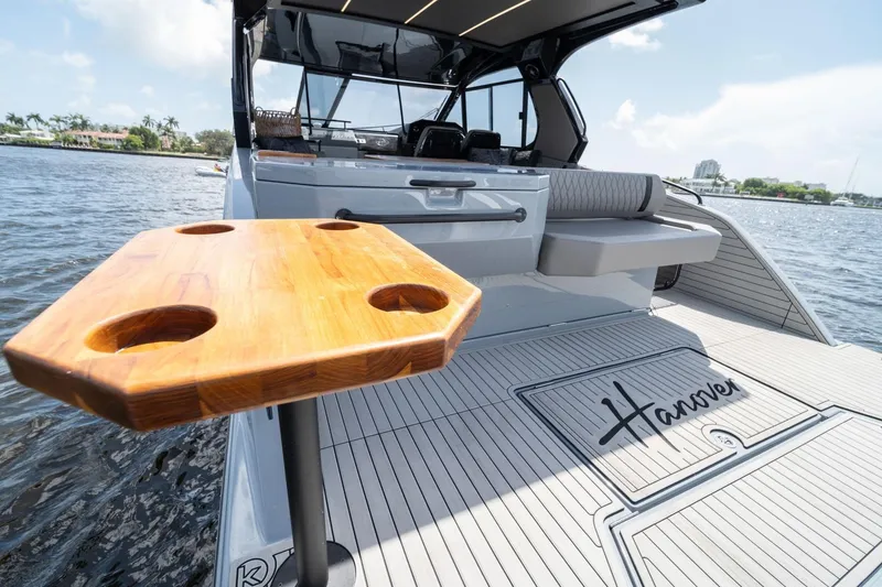 Slide: The Image of Luxury Hanover 387 yacht deck with wooden table, 2025 model, on a sunny day. - 17