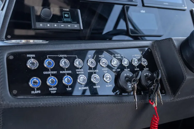 Slide: The Image of Control panel of a 2025 Hanover 387 boat with switches and keys. - 32