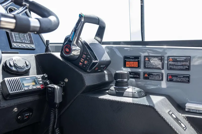 Slide: The Image of Control panel of 2025 Hanover 387 boat with steering wheel and navigation equipment. - 33