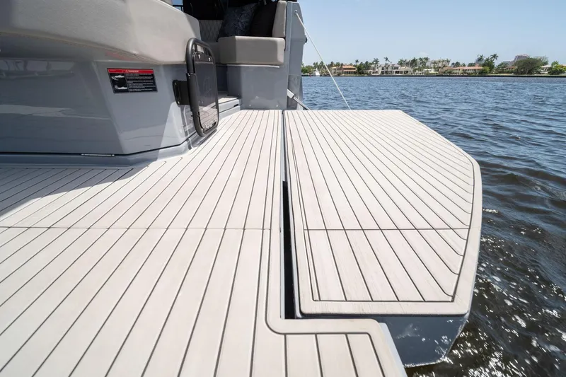 Slide: The Image of Luxury Hanover 387 yacht deck, 2025 model, on calm water with scenic shoreline view. - 37