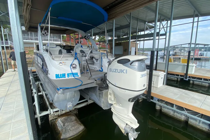 Slide: The Image of 2018 Manitou 25 X-Plode SRW SHP pontoon boat with Suzuki 350 outboard motor in dock. - 11