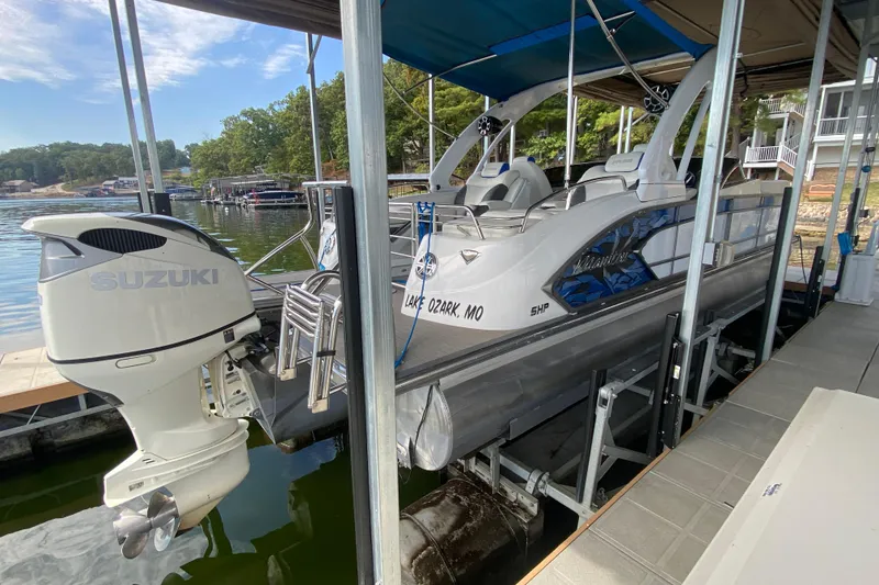 Slide: The Image of 2018 Manitou 25 X-Plode SRW SHP pontoon boat docked with Suzuki outboard motor. - 12