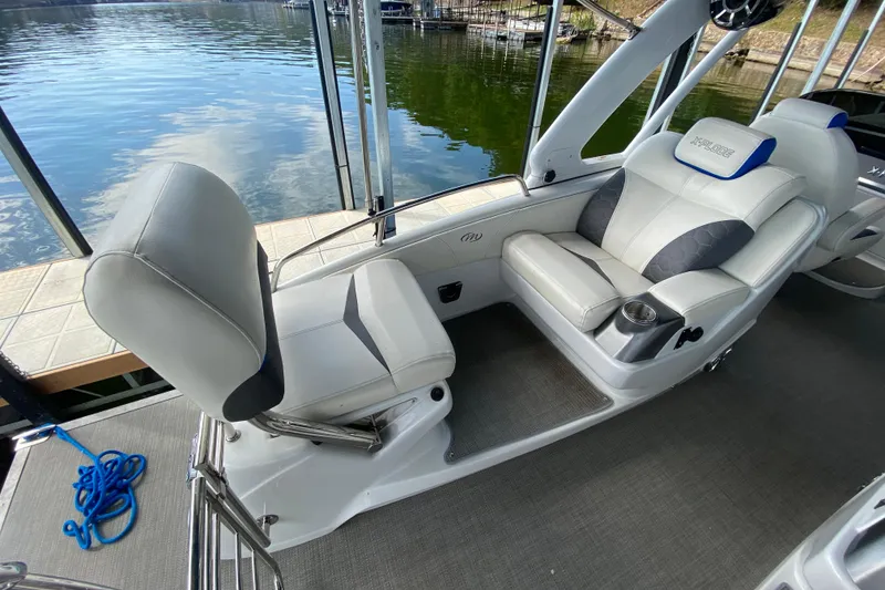 Slide: The Image of 2018 Manitou 25 X-Plode SRW SHP boat interior with plush seating and cup holder. - 15