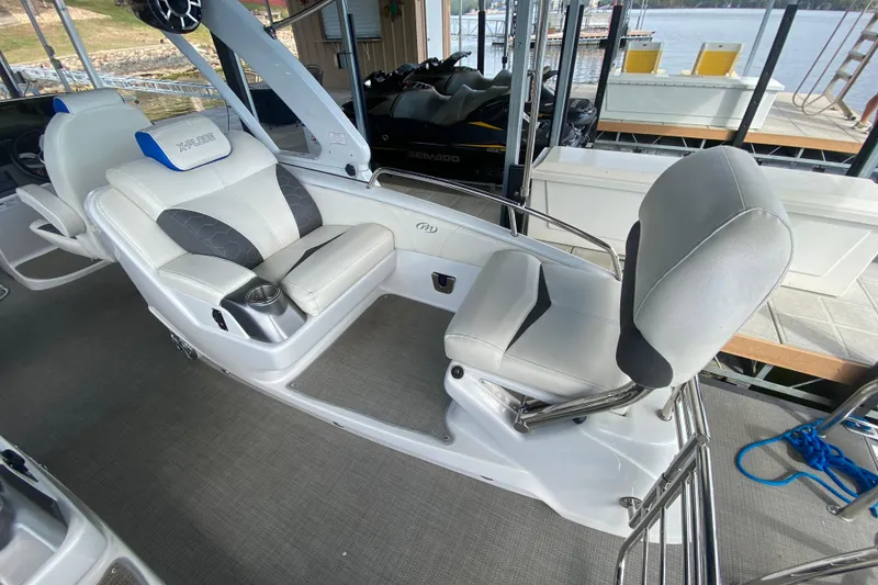 Slide: The Image of 2018 Manitou 25 X-Plode SRW SHP boat interior with plush seating and cup holders. - 16