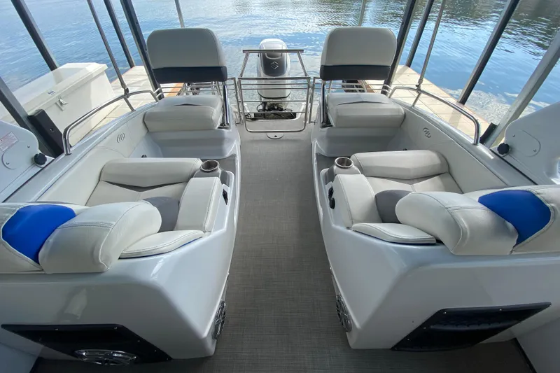Slide: The Image of 2018 Manitou 25 X-Plode SRW SHP boat interior with luxurious seating and lake view. - 20