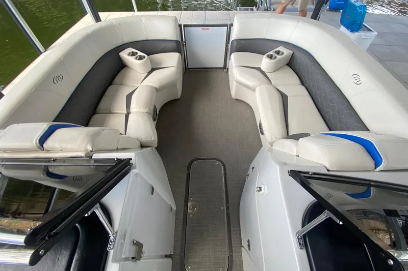 Slide: The Image of 2018 Manitou 25 X-Plode SRW SHP boat interior with luxurious seating and cup holders. - 31