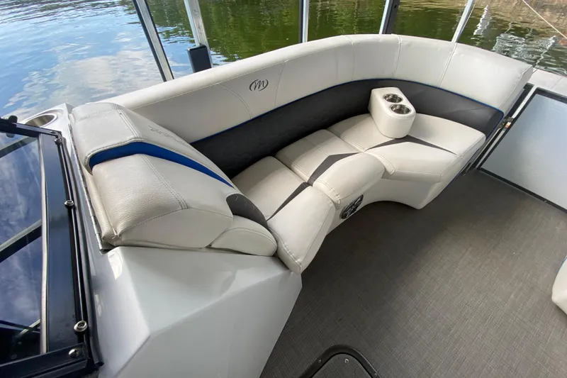 Slide: The Image of 2018 Manitou 25 X-Plode SRW SHP boat interior with plush seating and cup holders. - 32