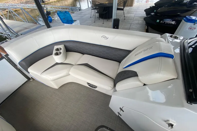 Slide: The Image of 2018 Manitou 25 X-Plode SRW SHP boat interior with white and gray seating. - 33