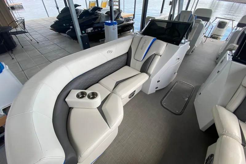 Slide: The Image of 2018 Manitou 25 X-Plode SRW SHP boat interior with luxurious seating and cup holders. - 34