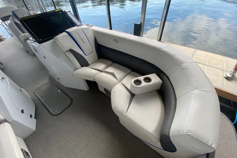 Slide: The Image of 2018 Manitou 25 X-Plode SRW SHP boat interior with plush seating and cup holders. - 35
