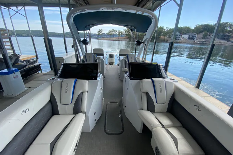 Slide: The Image of 2018 Manitou 25 X-Plode SRW SHP pontoon boat interior at a lakeside dock. - 36