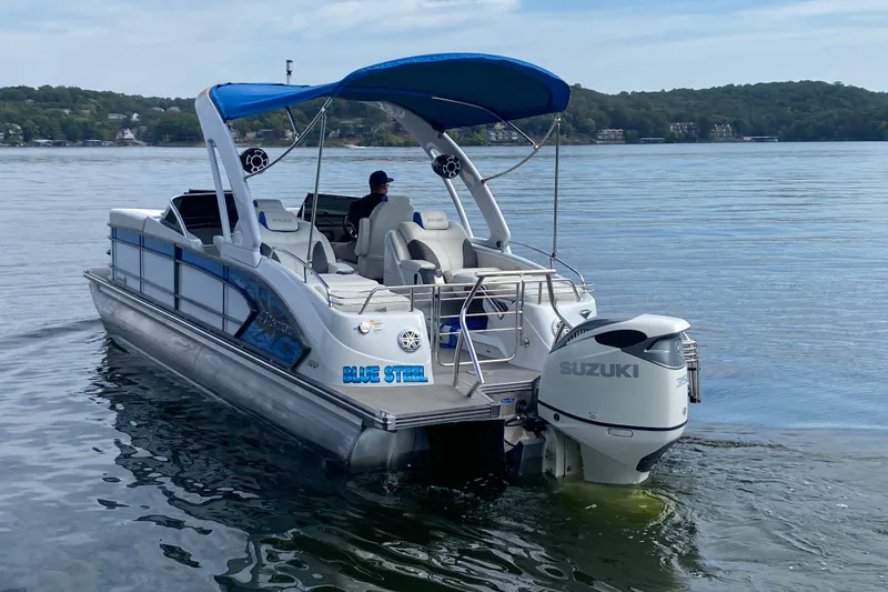 Slide: The Image of 2018 Manitou 25 X-Plode SRW SHP pontoon boat on a lake with Suzuki outboard. - 4