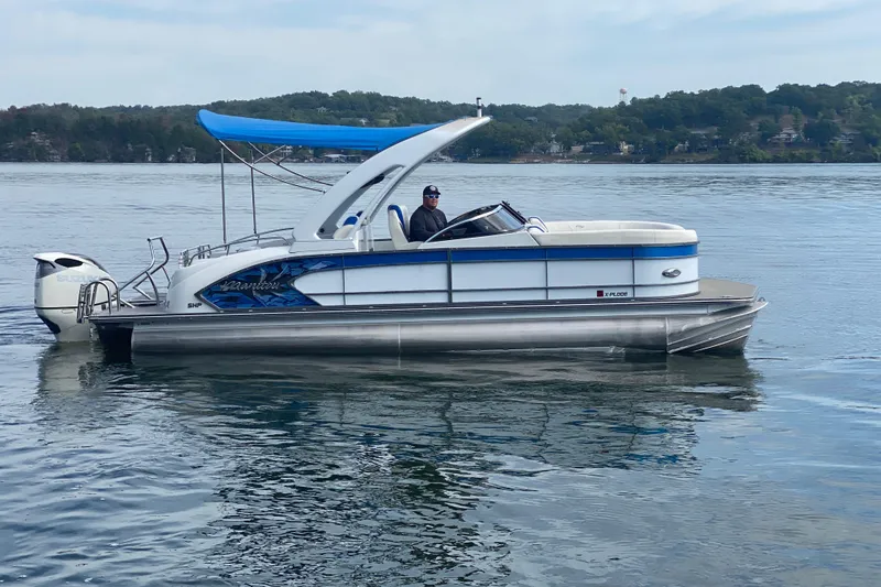 Slide: The Image of 2018 Manitou 25 X-Plode SRW SHP pontoon boat on a calm lake. - 5
