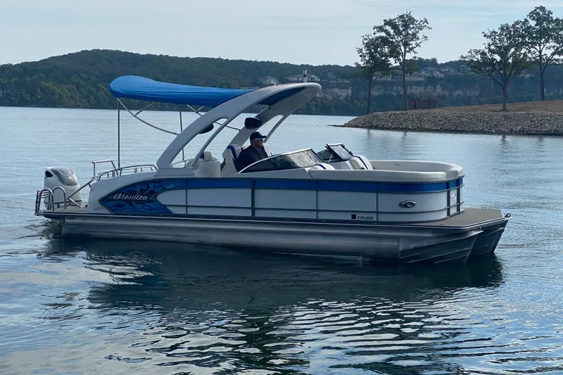 Slide: The Image of 2018 Manitou 25 X-Plode SRW SHP pontoon boat on a calm lake. - 7