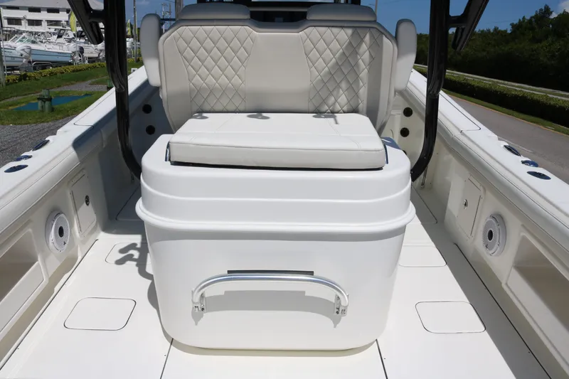 Slide: The Image of 2026 World Cat 295 CC boat interior with cushioned seating and storage compartment. - 12