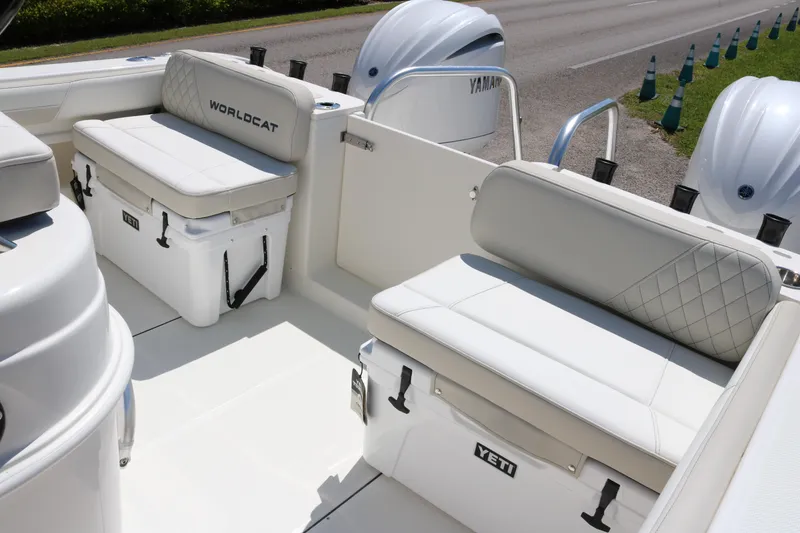 Slide: The Image of 2026 World Cat 295 CC boat interior with Yeti coolers and Yamaha engines. - 14