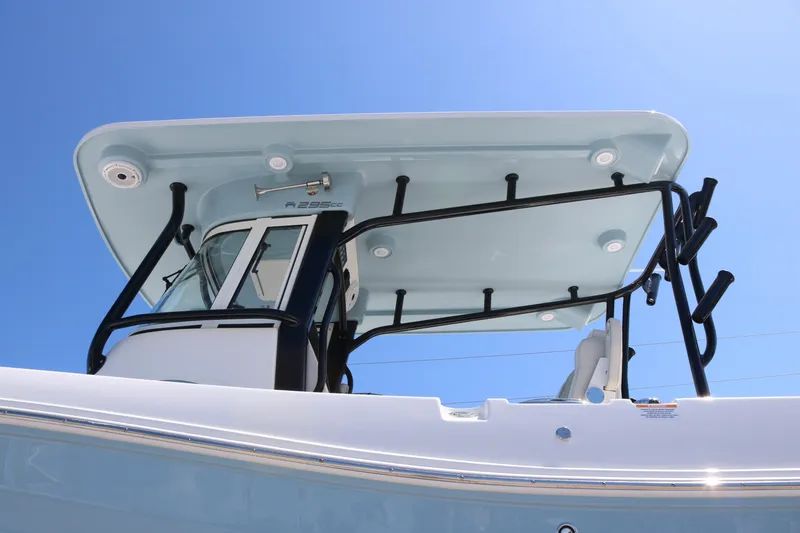 Slide: The Image of 2026 World Cat 295 CC boat with sleek T-top design under clear blue sky. - 5