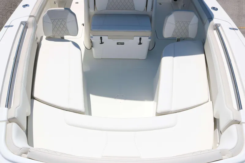 Slide: The Image of 2026 World Cat 295 CC boat interior with cushioned seating and Yeti cooler. - 7