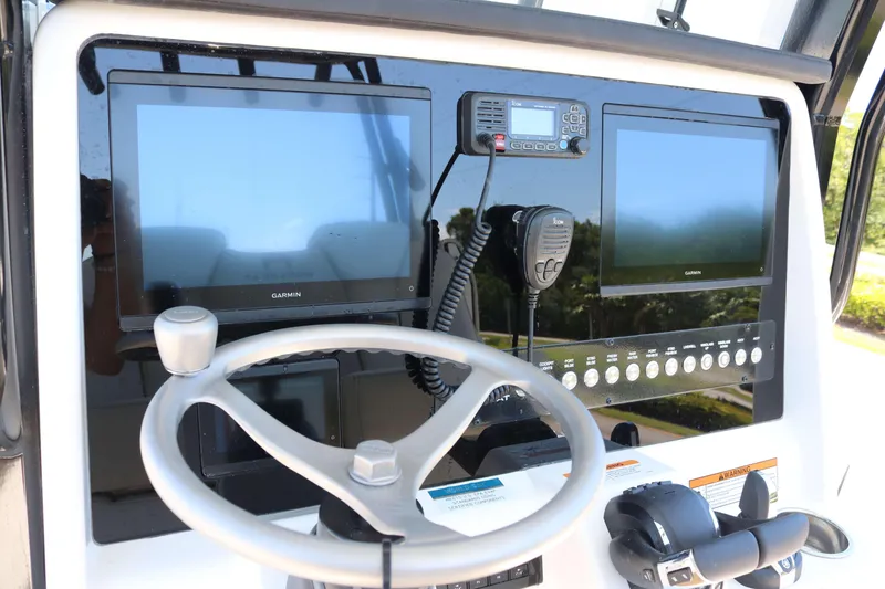 Slide: The Image of Steering console of 2026 World Cat 295 CC with Garmin displays and controls. - 8