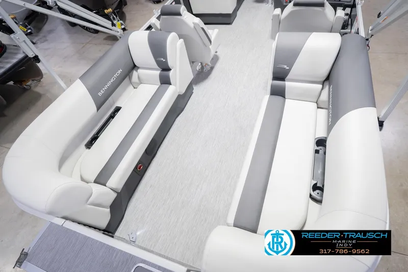 Slide: The Image of 2026 Bennington 22 SSR pontoon boat interior with gray and white seating, Reeder-Trausch Marine logo. - 14