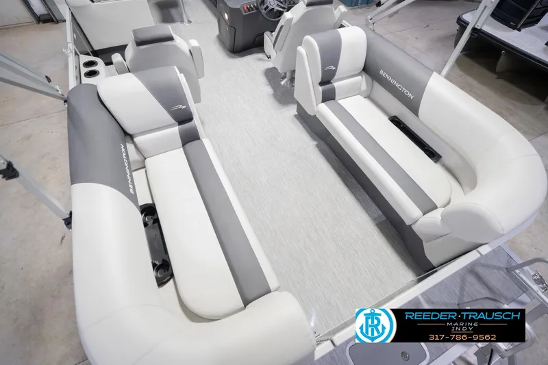 Slide: The Image of 2026 Bennington 22 SSR boat interior with gray and white seating, Reeder-Trausch Marine logo. - 15
