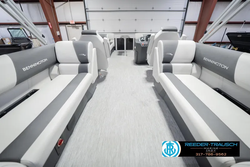Slide: The Image of 2026 Bennington 22 SSR pontoon boat interior with gray and white seating in a showroom. - 19