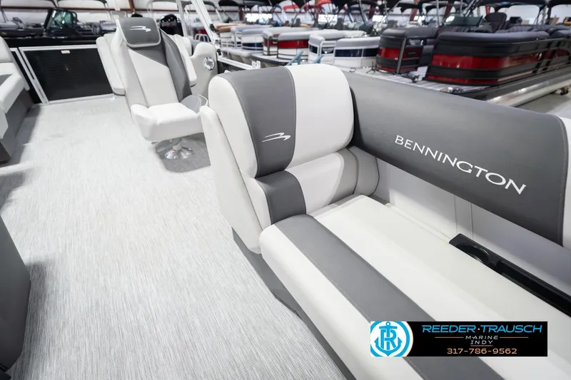 Slide: The Image of 2026 Bennington 22 SSR boat interior with gray and white seating, showroom display. - 24
