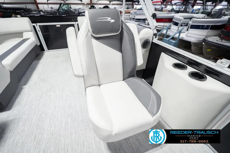 Slide: The Image of 2026 Bennington 22 SSR boat seat with cup holders in showroom setting. - 26