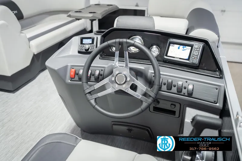 Slide: The Image of 2026 Bennington 22 SSR boat dashboard with steering wheel and navigation controls. - 31