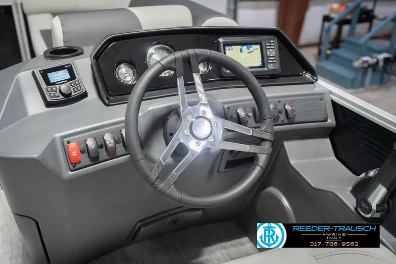 Slide: The Image of 2026 Bennington 22 SSR boat dashboard with steering wheel and navigation controls. - 32