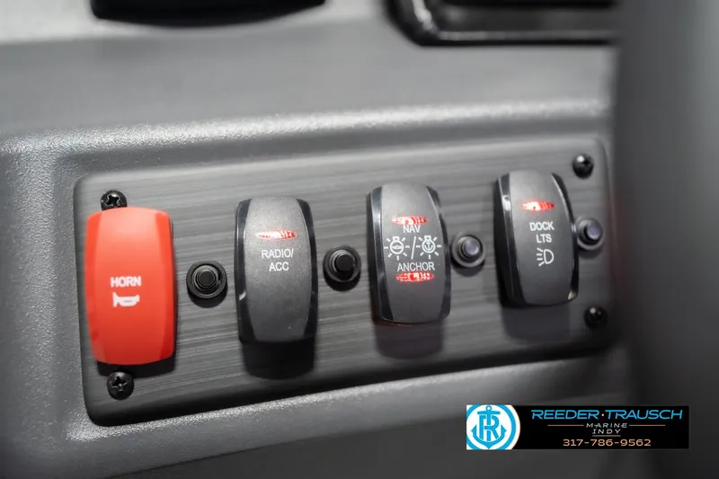 Slide: The Image of Control panel of 2026 Bennington 22 SSR boat with switches for horn, radio, and lights. - 34