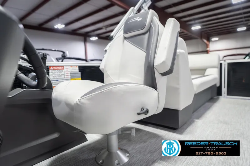 Slide: The Image of 2026 Bennington 22 SSR boat interior with white captain's chair in showroom. - 40