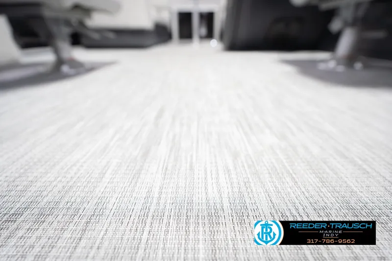 Slide: The Image of 2026 Bennington 22 SSR boat interior flooring, featuring textured design and Reeder-Trausch Marine logo. - 47