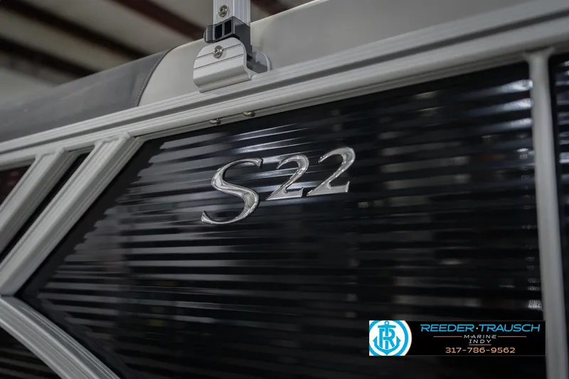 Slide: The Image of 2026 Bennington 22 SSR boat with sleek black paneling and S22 emblem. - 50