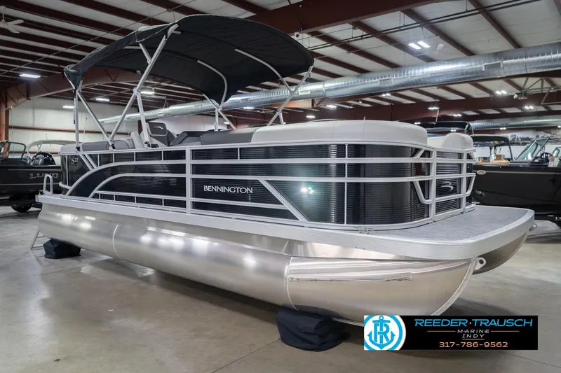 Slide: The Image of 2026 Bennington 22 SSR pontoon boat in showroom, featuring sleek design and canopy. - 6