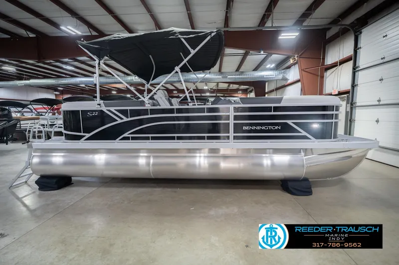 Slide: The Image of 2026 Bennington 22 SSR pontoon boat in showroom with canopy and sleek design. - 7