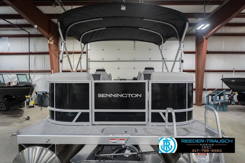 Slide: The Image of 2026 Bennington 22 SSR pontoon boat in showroom, featuring sleek design and canopy. - 9