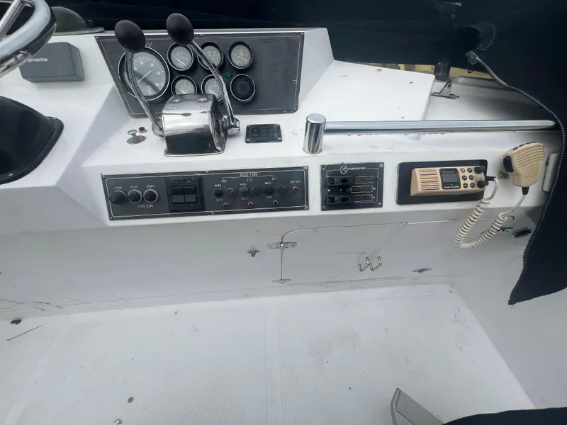 Slide: The Image of Control panel of a 1990 Pace 42 Motor Yacht with gauges and communication equipment. - 12